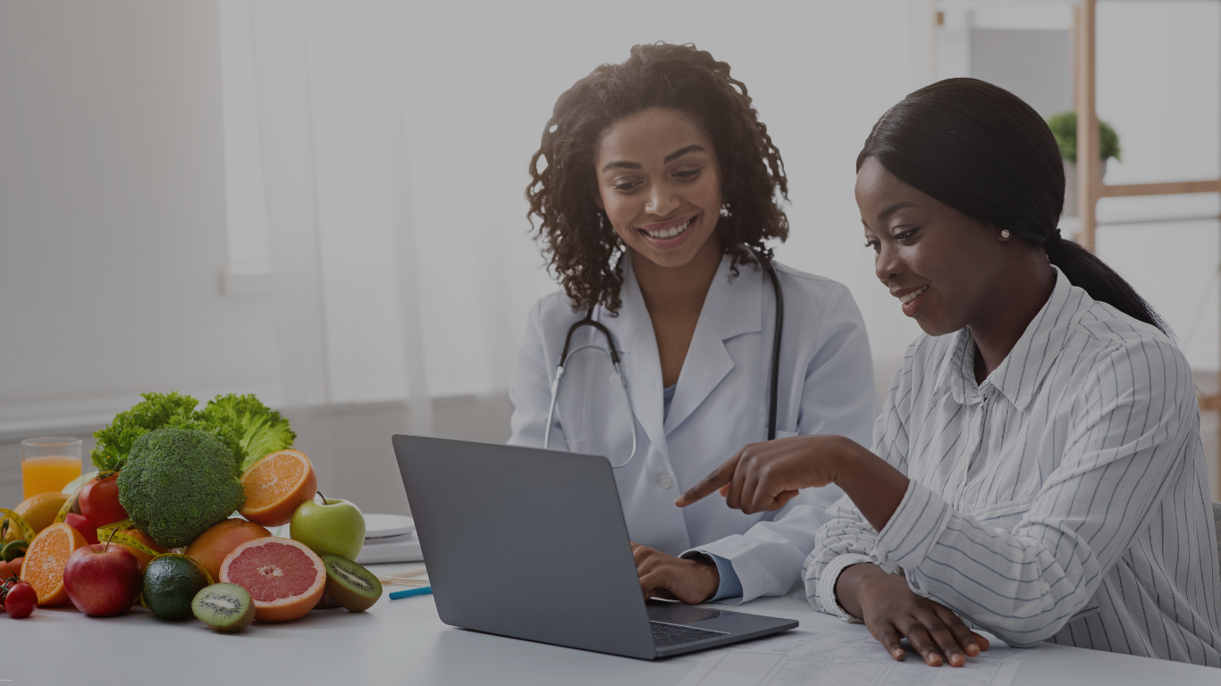 A woman is sitting on a table talking to a doctor.