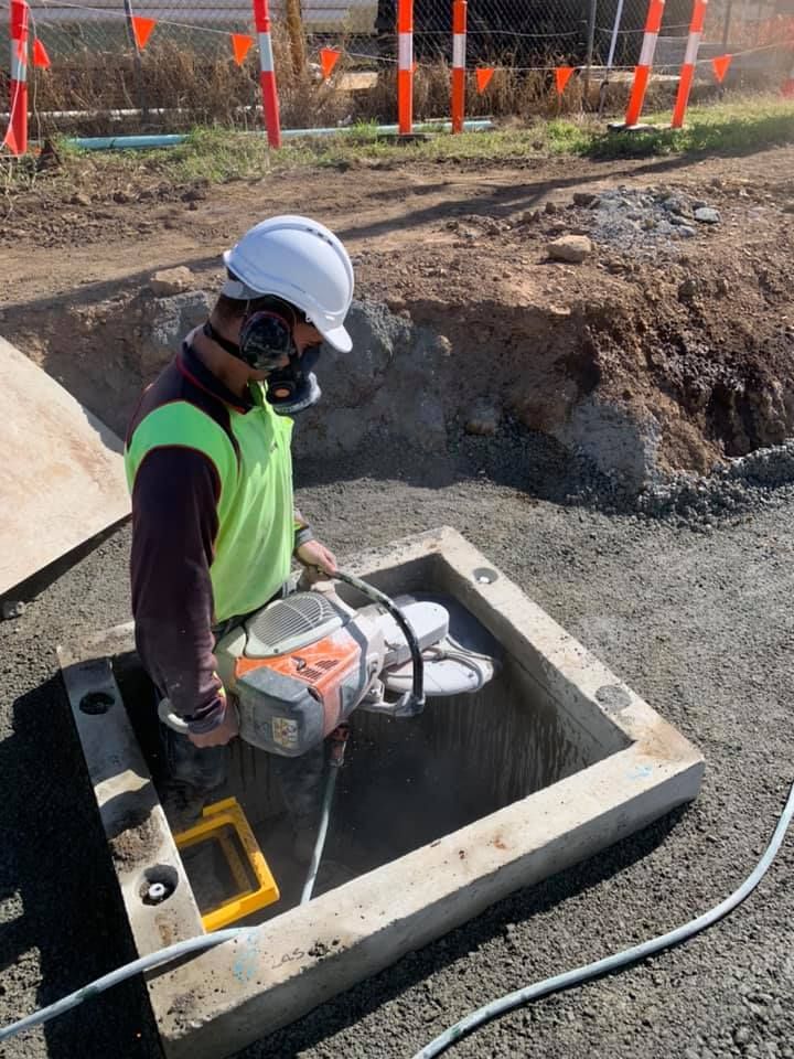 Construction Worker Cutting Into a Concrete Access Box — Dondarra Concrete Cutting & Drilling in Parkhurst, QLD