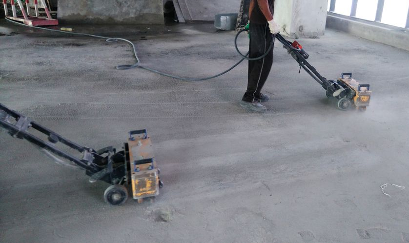 Two Workers Grinding Concrete Floor With Machinery — Dondarra Concrete Cutting & Drilling in Parkhurst, QLD