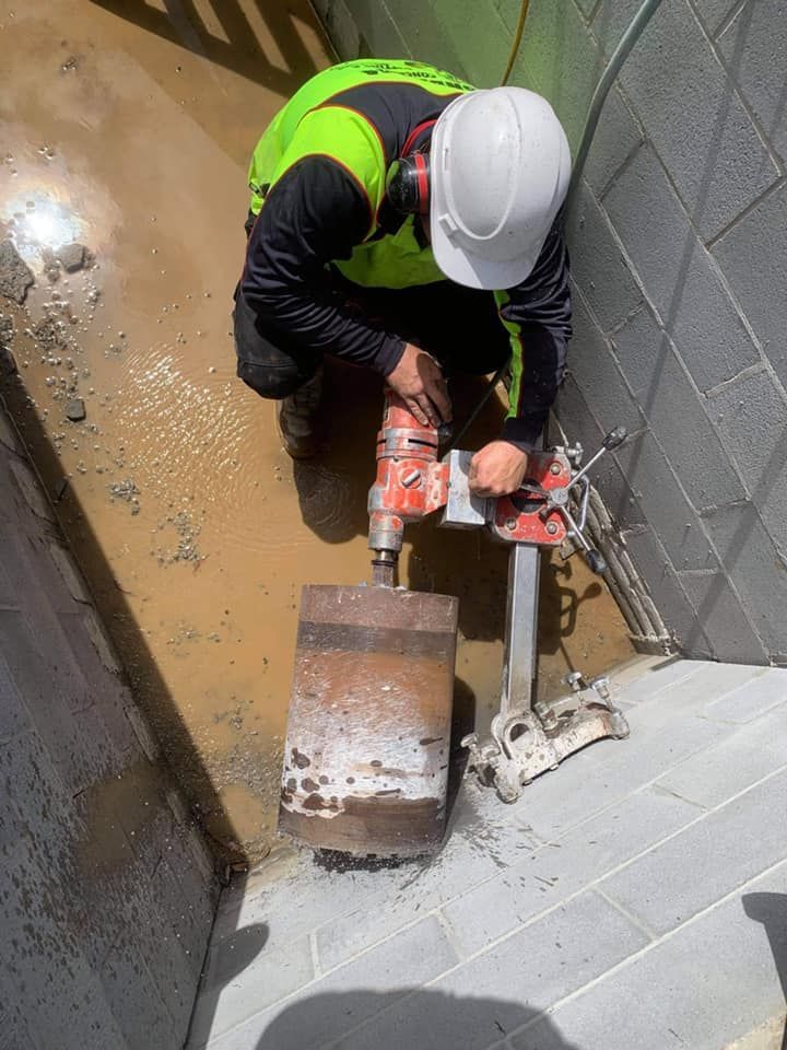 Worker Drilling Concrete With a Large Dril — Dondarra Concrete Cutting & Drilling in Parkhurst, QLD