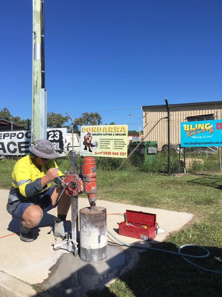 Worker Using a Core Drill on Concrete — Dondarra Concrete Cutting & Drilling in Parkhurst, QLD
