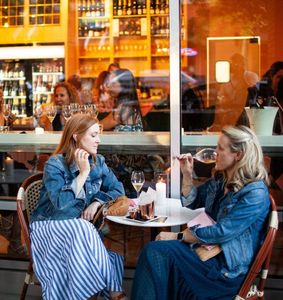 two ladies sipping champagne outside of Fizz Champagne & Bubbles Bar in Walnut Creek.