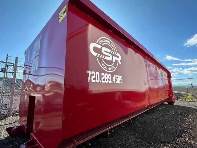 A red dumpster with csr written on it