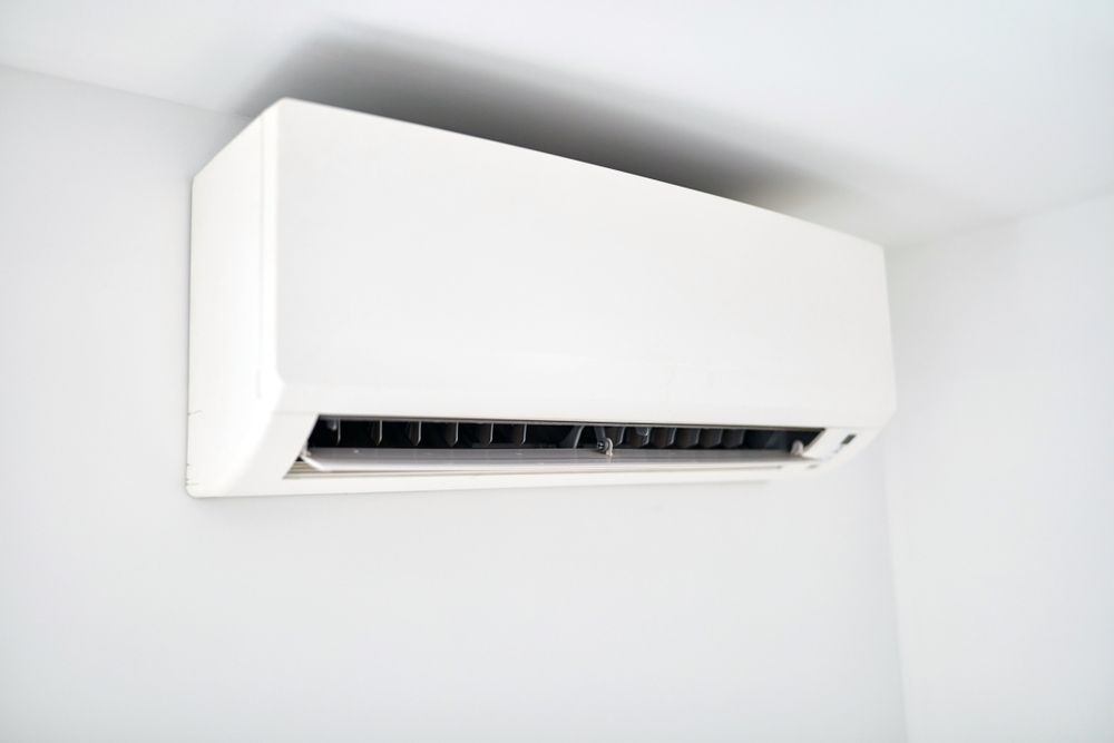 A White Air Conditioner Is Hanging From The Ceiling In A Room — Climatech In Nambour, QLD