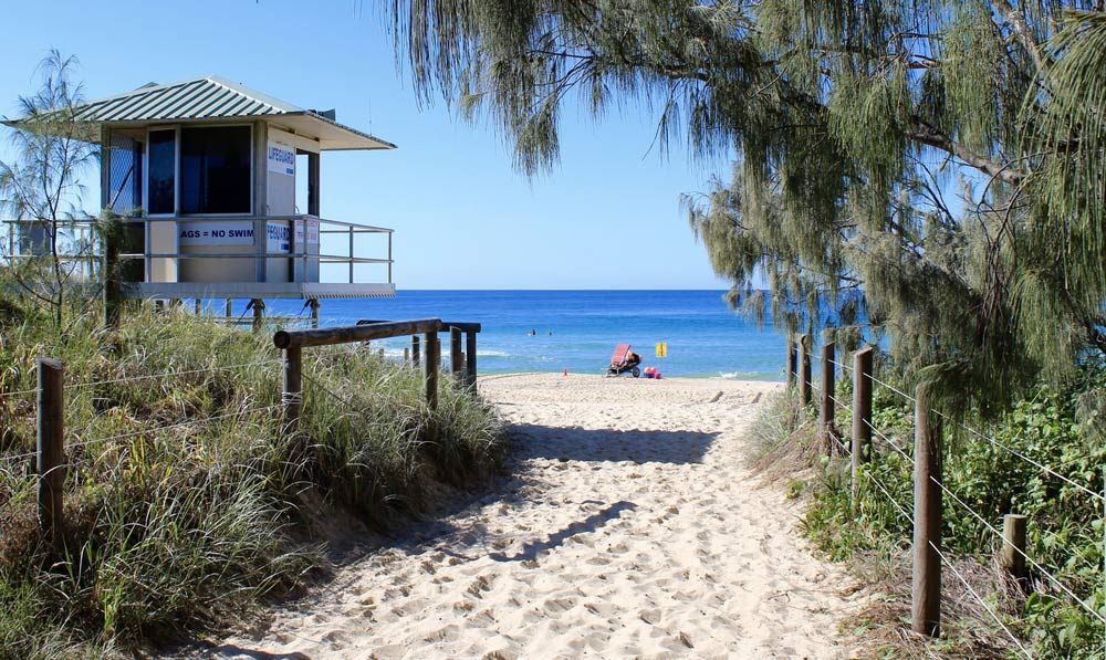 A Path Leading To A Beach With A Lifeguard Tower In The Background — Climatech In Maroochydore, QLD