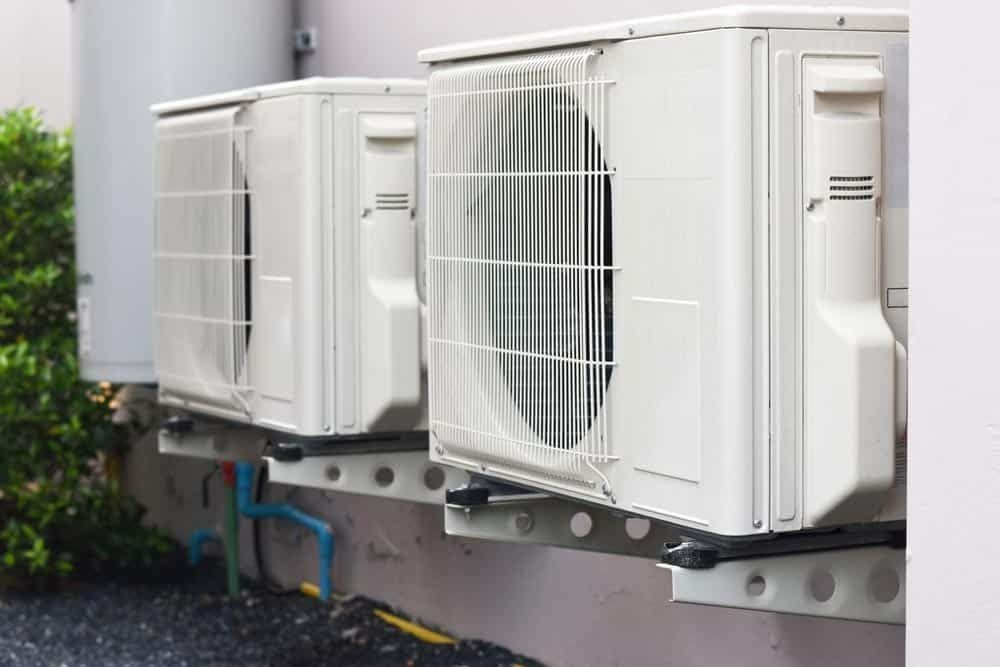 Three Air Conditioners Are Mounted On The Side Of A Building — Climatech In Marcoola, QLD