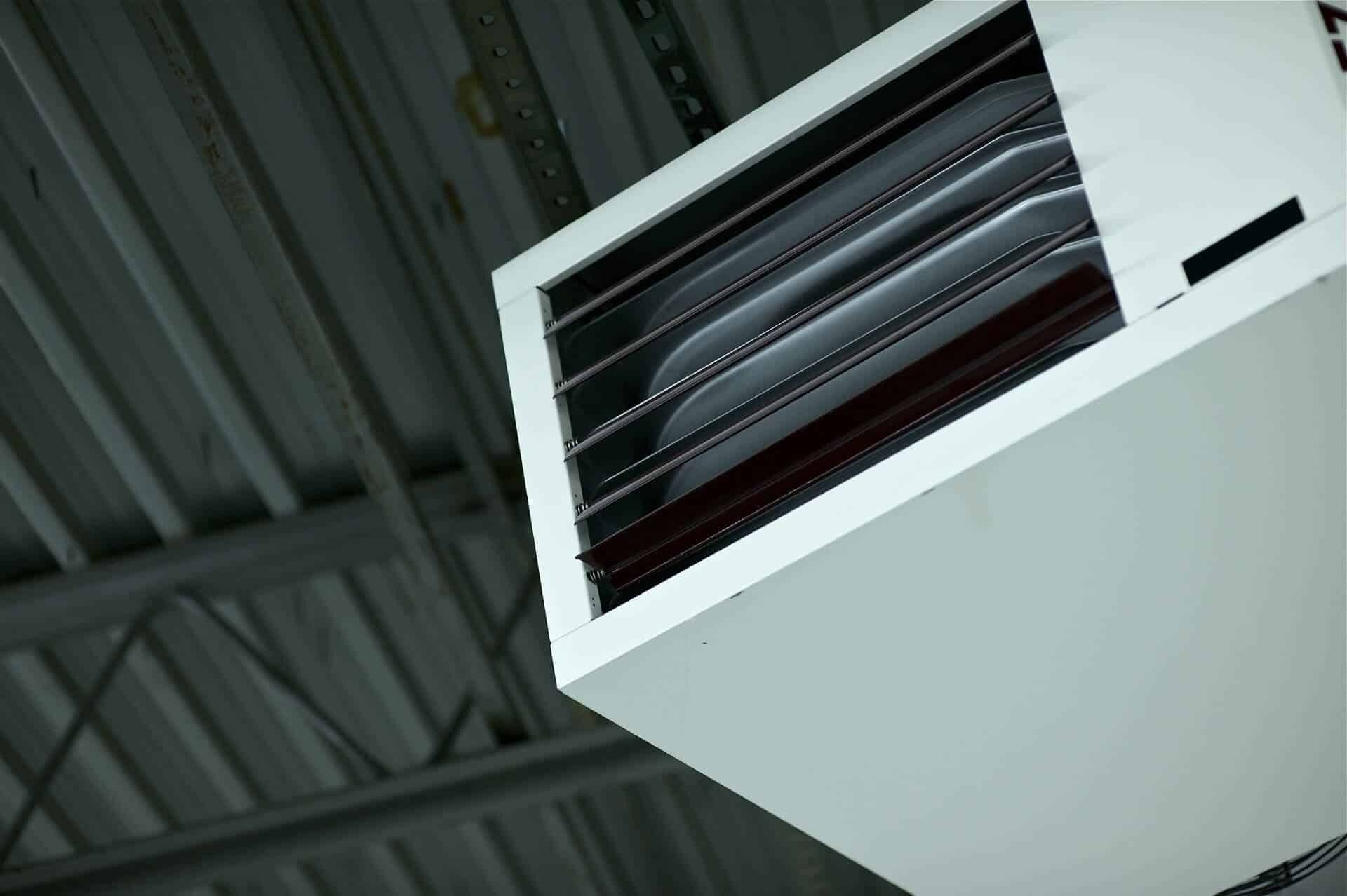 A White Heater Is Hanging From The Ceiling Of A Building — Climatech In Marcoola, QLD