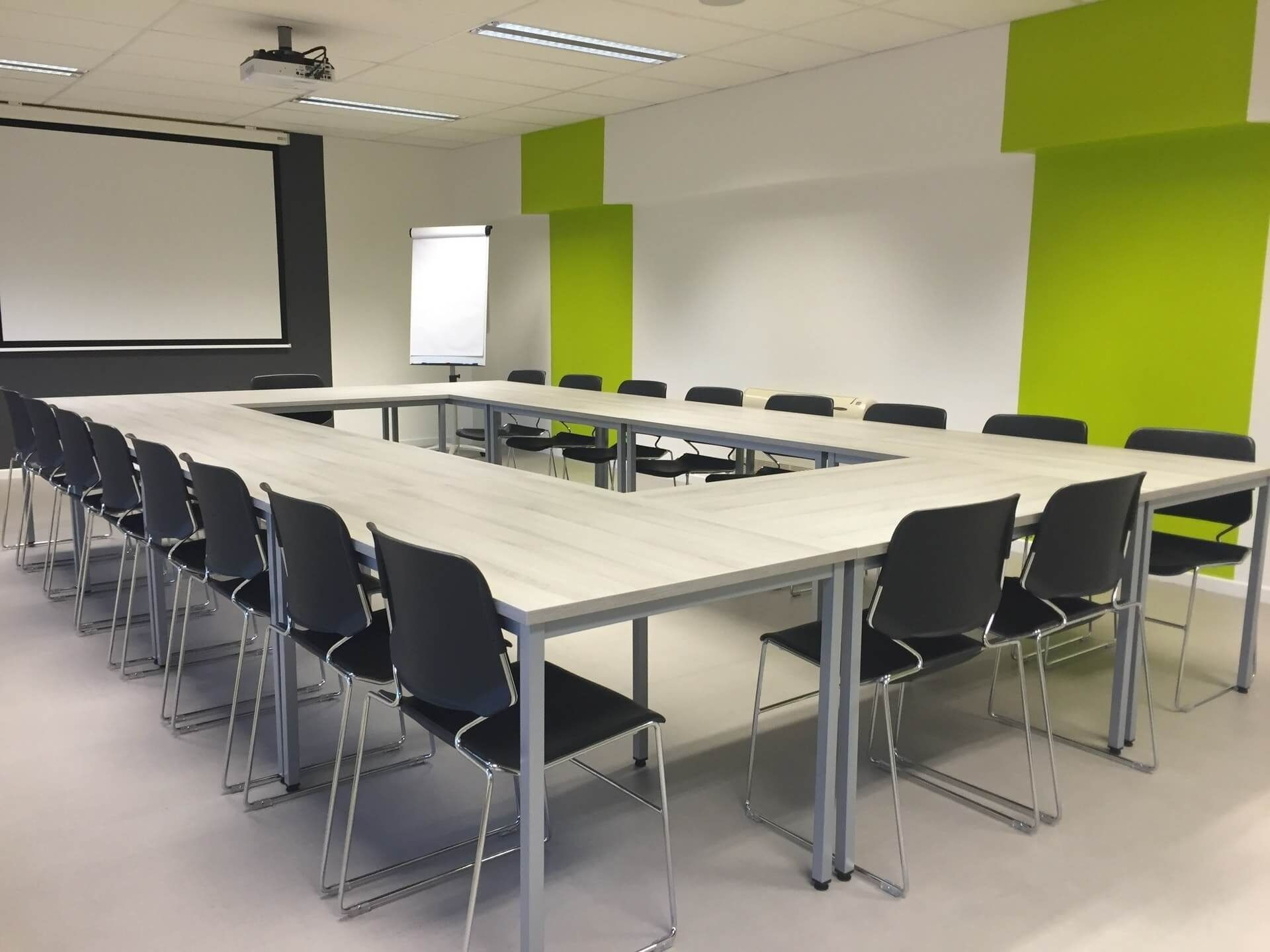 A Conference Room With Tables And Chairs And A Projector Screen — Climatech In Maroochydore, QLD