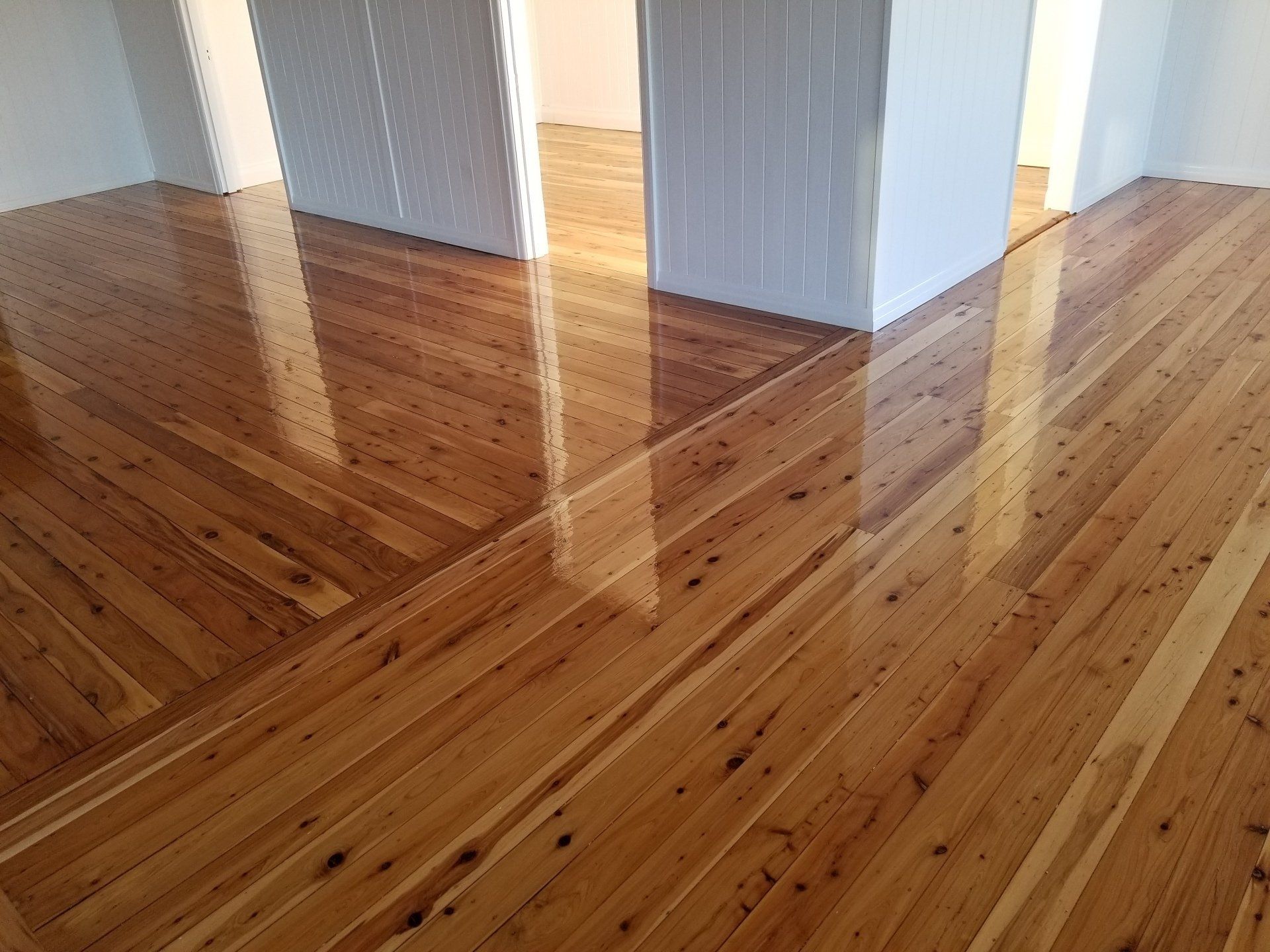 Polished hardwood floor with diagonal grain pattern, reflecting the room's light. — The Good Wood Polished Timber Floors in Westbrook, QLD