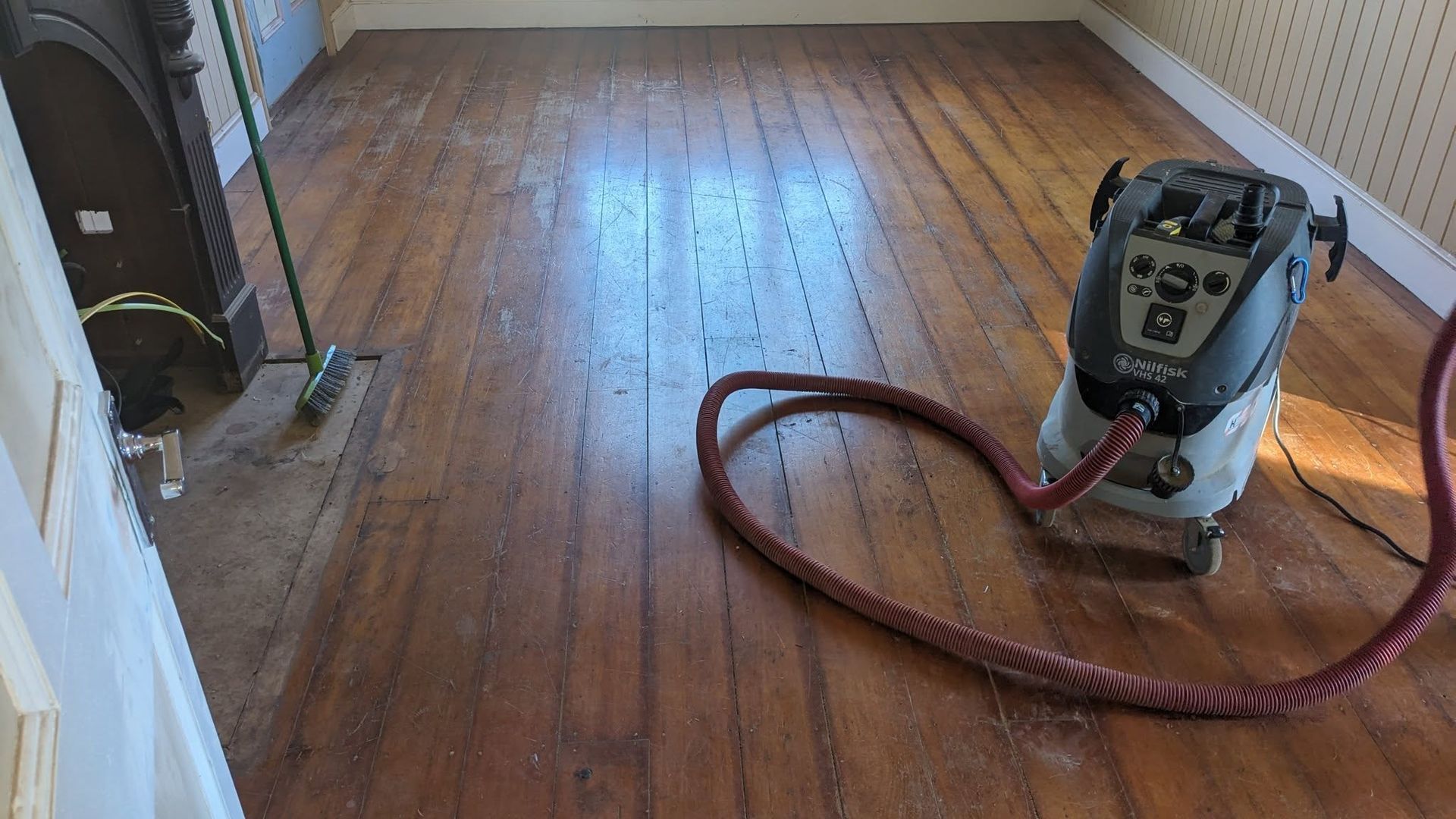 Vacuum Cleaner on Hardwood Floor During a Sanding Project — The Good Wood Polished Timber Floors in Westbrook, QLD