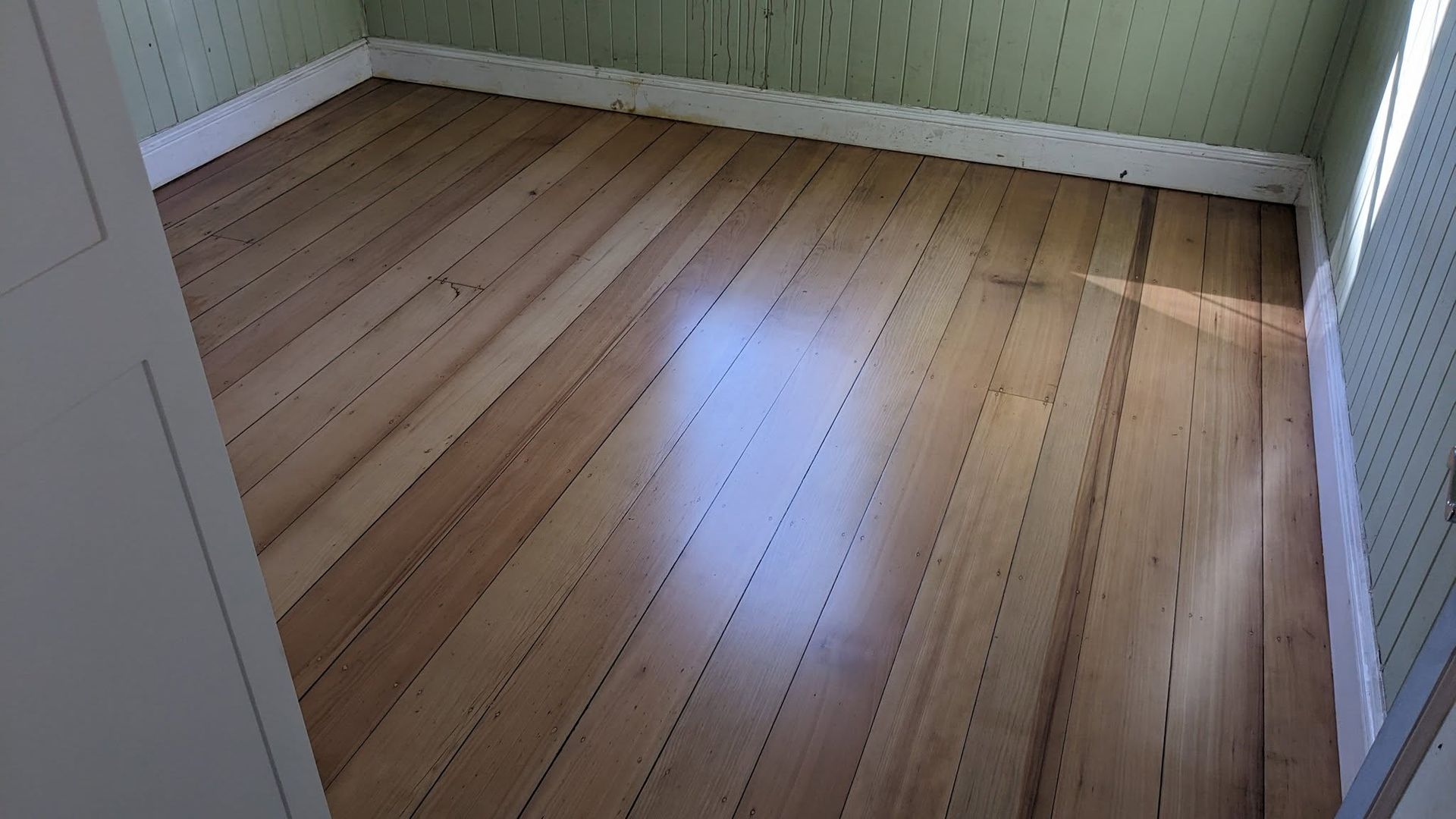 Hardwood Floor in a Room With Green Patterned Walls — The Good Wood Polished Timber Floors in Westbrook, QLD