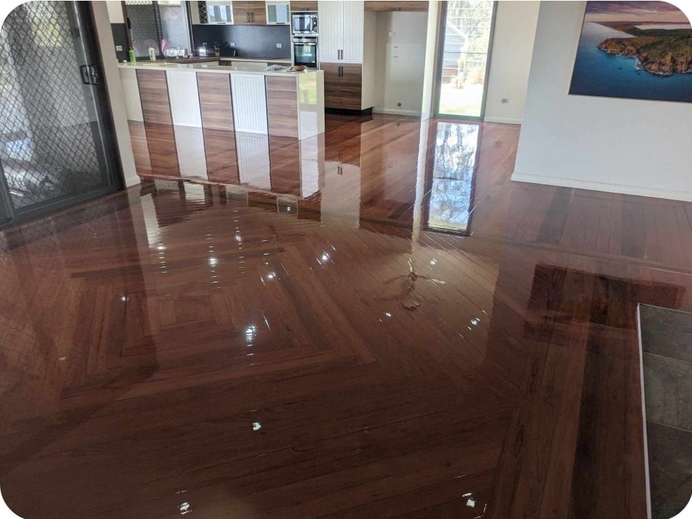 Glossy Wooden Floor Reflecting a Kitchen — The Good Wood Polished Timber Floors in Westbrook, QLD