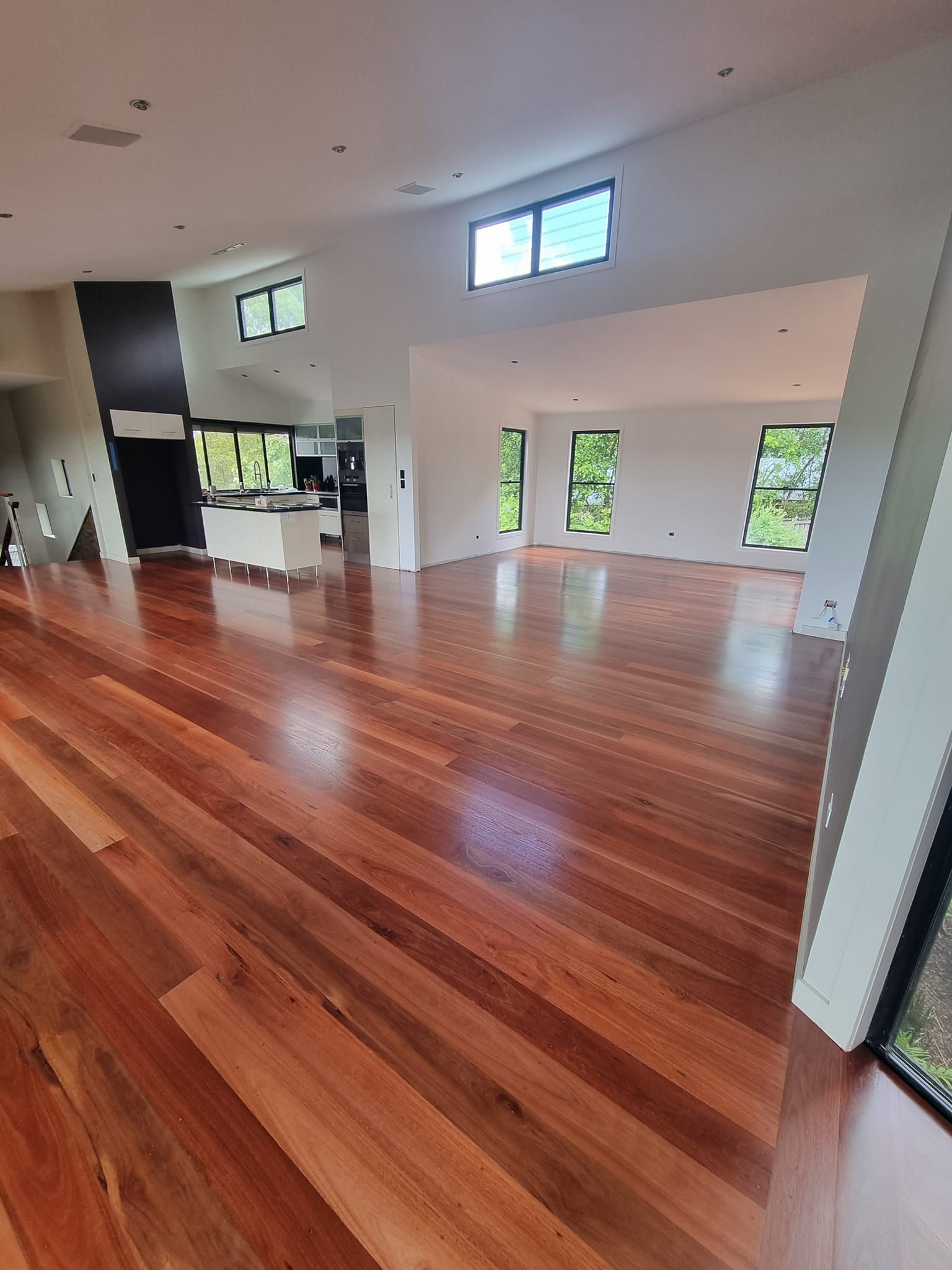 Spacious Interior With Polished Hardwood Floors and White Walls — The Good Wood Polished Timber Floors in Highfields, QLD