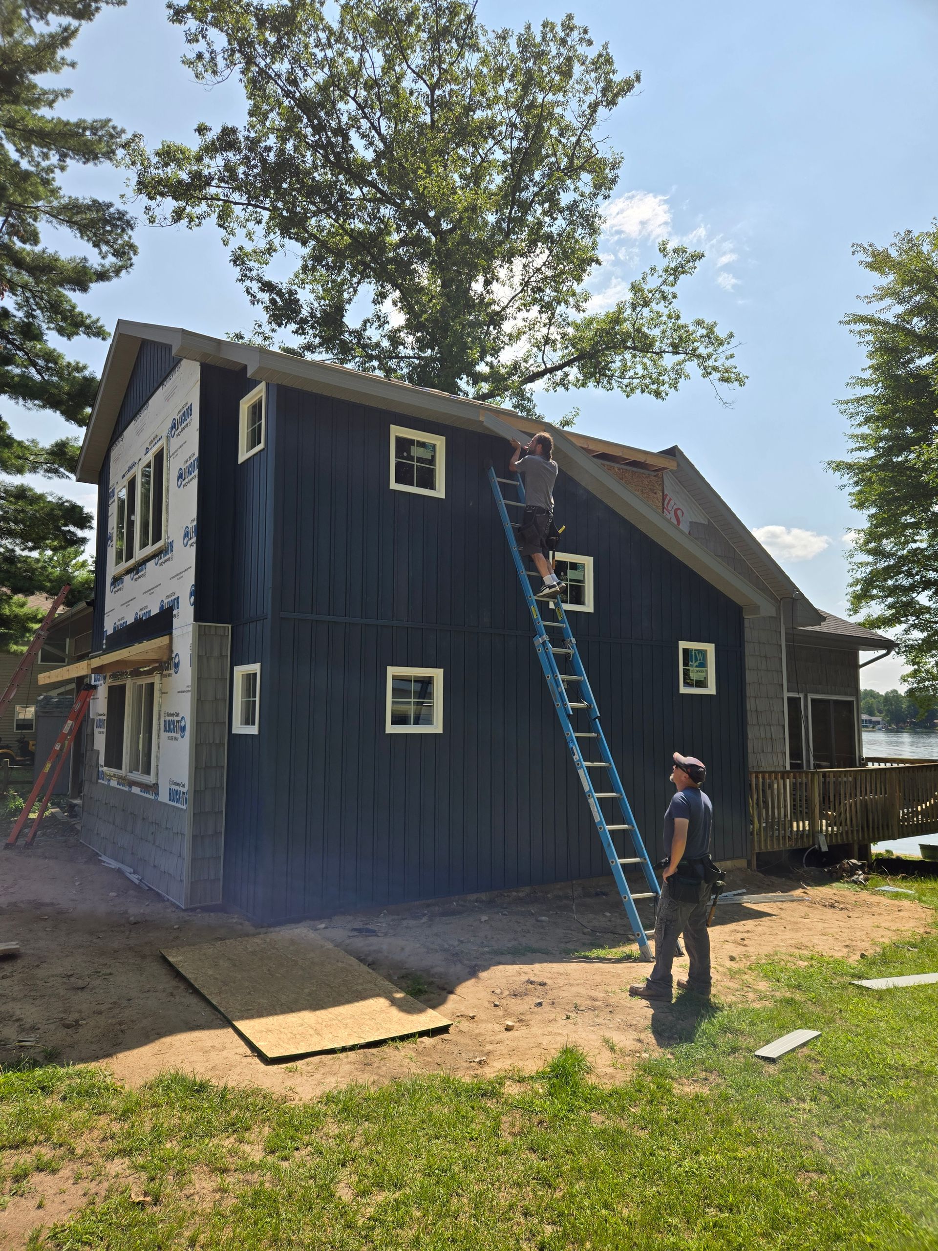 View of the house with new siding installation.