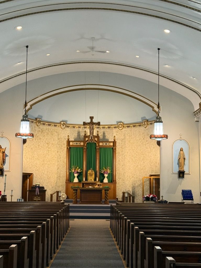 A church with rows of pews and a cross on the altar