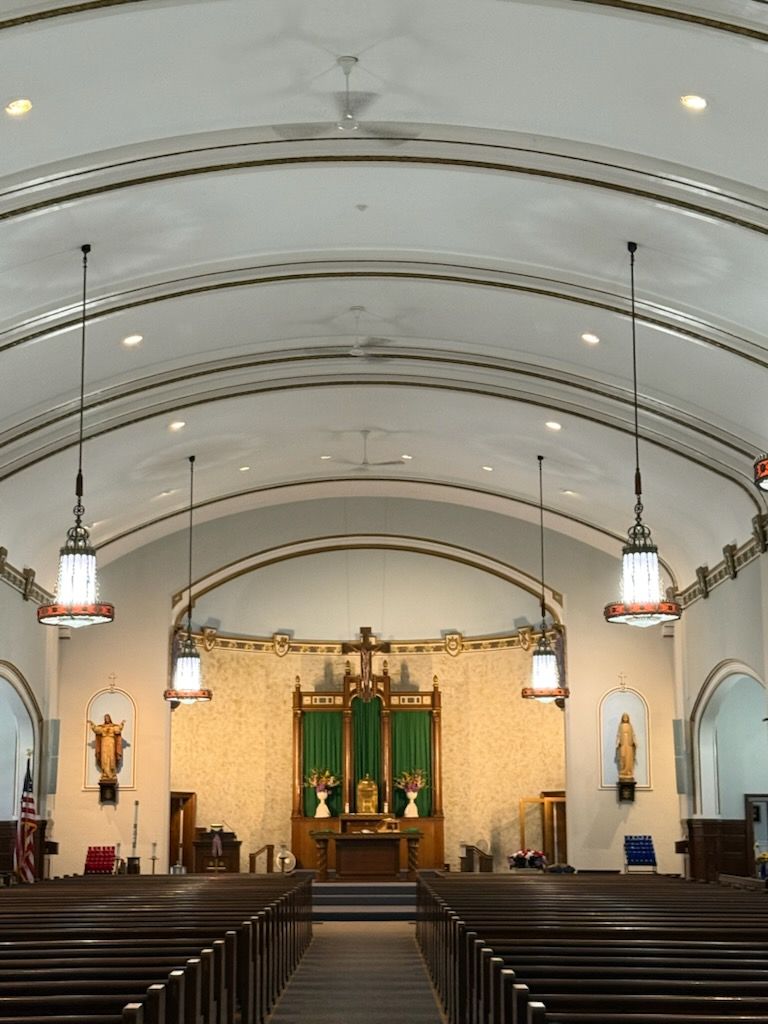 A church with a vaulted ceiling and rows of pews