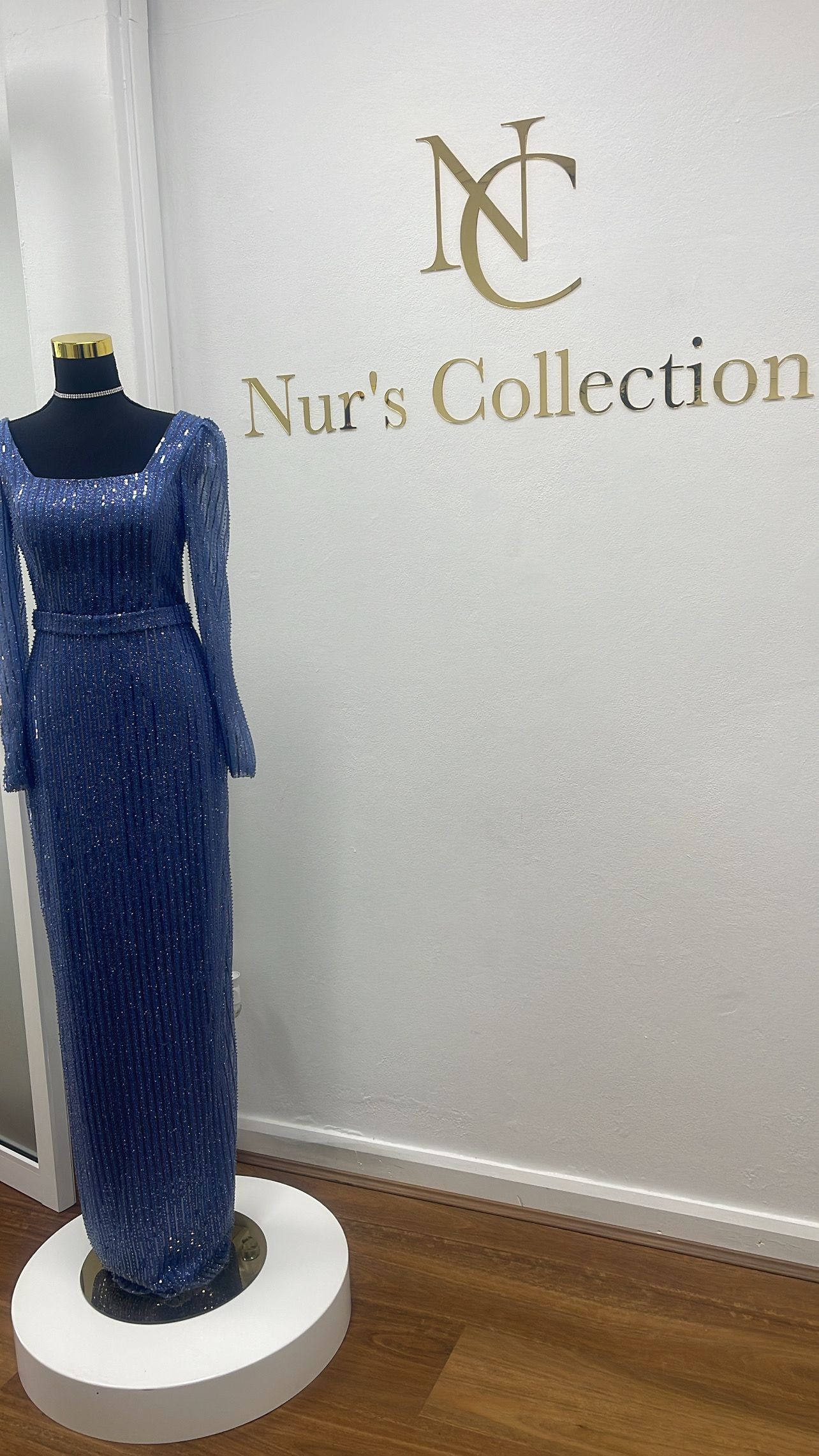 A sparkling blue evening gown on a mannequin in a store called Nur's Collectionβ Nur's Collection In Rockdale, NSW