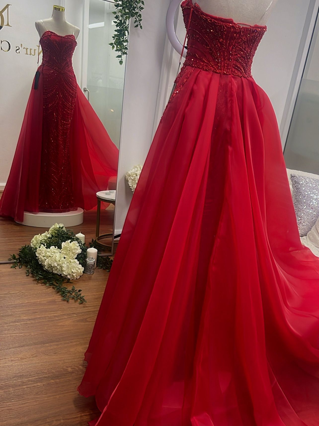 Red strapless gown with a beaded bodice and flowing skirt on a mannequin in a shop — Nur's Collection In Rockdale, NSW