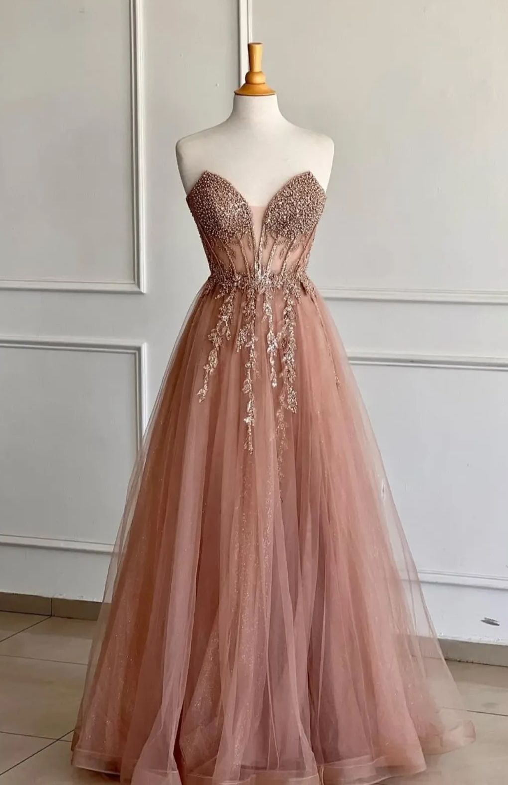 Dusty rose strapless evening gown on a mannequin, bodice with beadwork, tulle skirtβ Nur's Collection In Rockdale, NSW