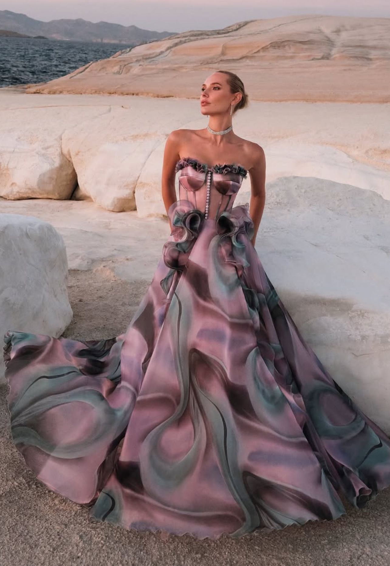 Woman in flowing gown, posing outdoors. Pink, purple, and gray swirls on dress. β Nur's Collection In Rockdale, NSW