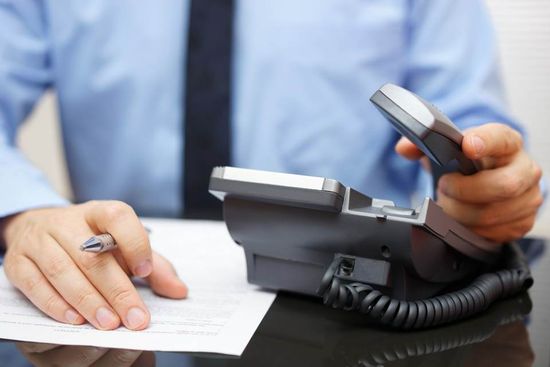 customer picking the phone to call the professional