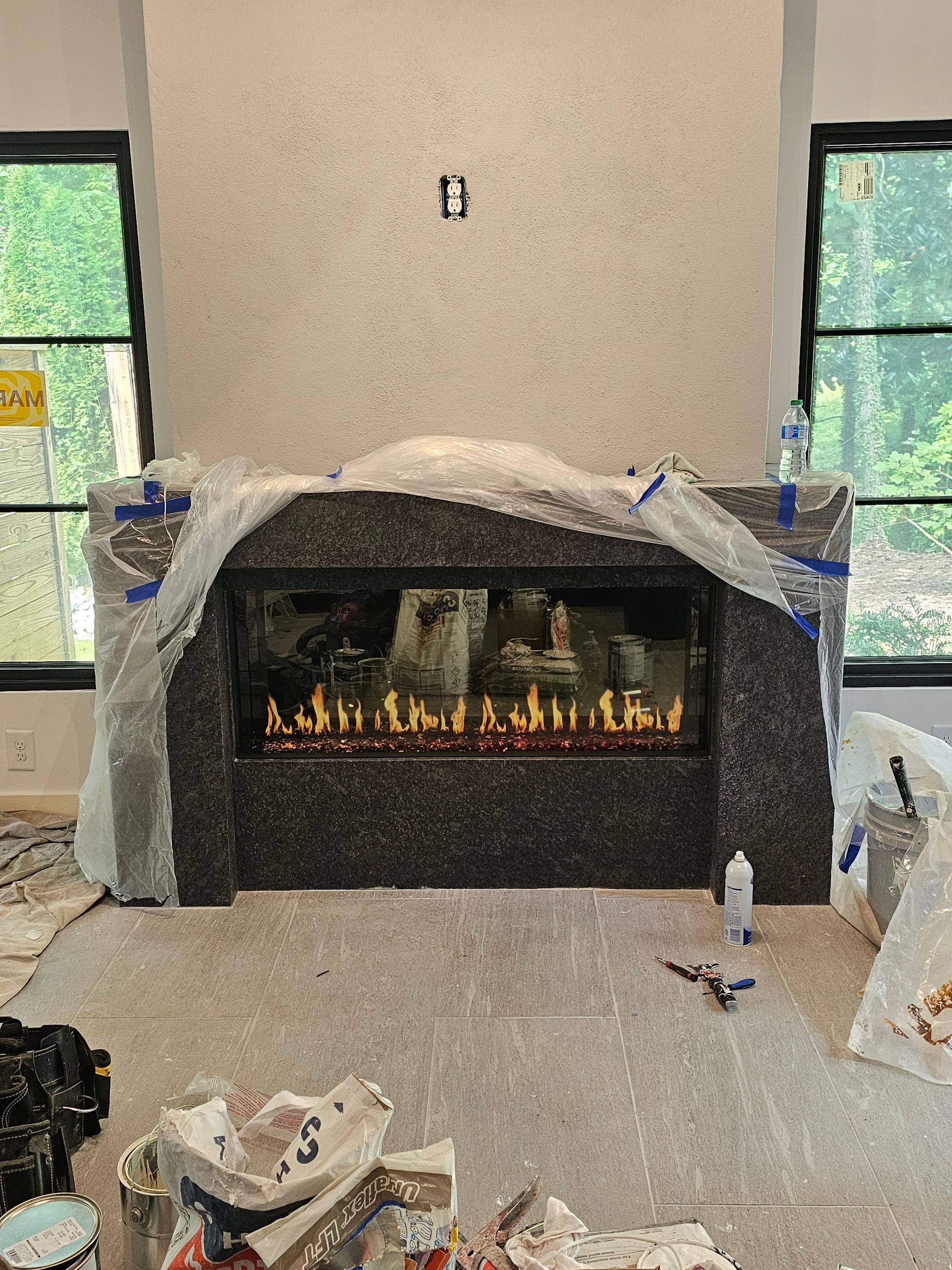A fireplace is being built in a living room.