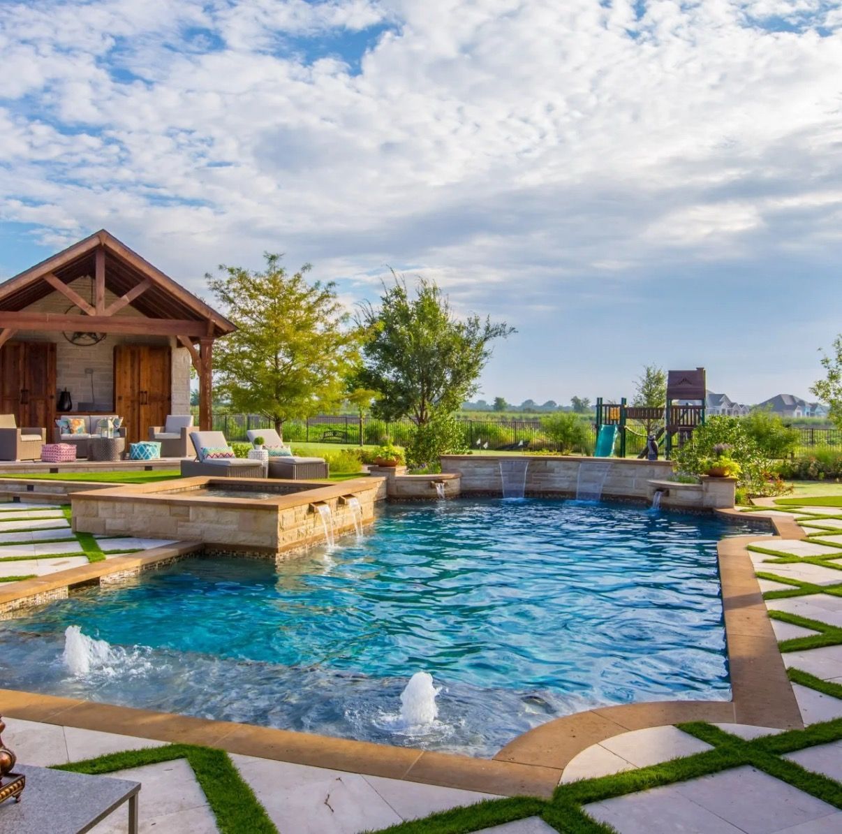 Pool with stainless steel ladder reflecting sunlight.