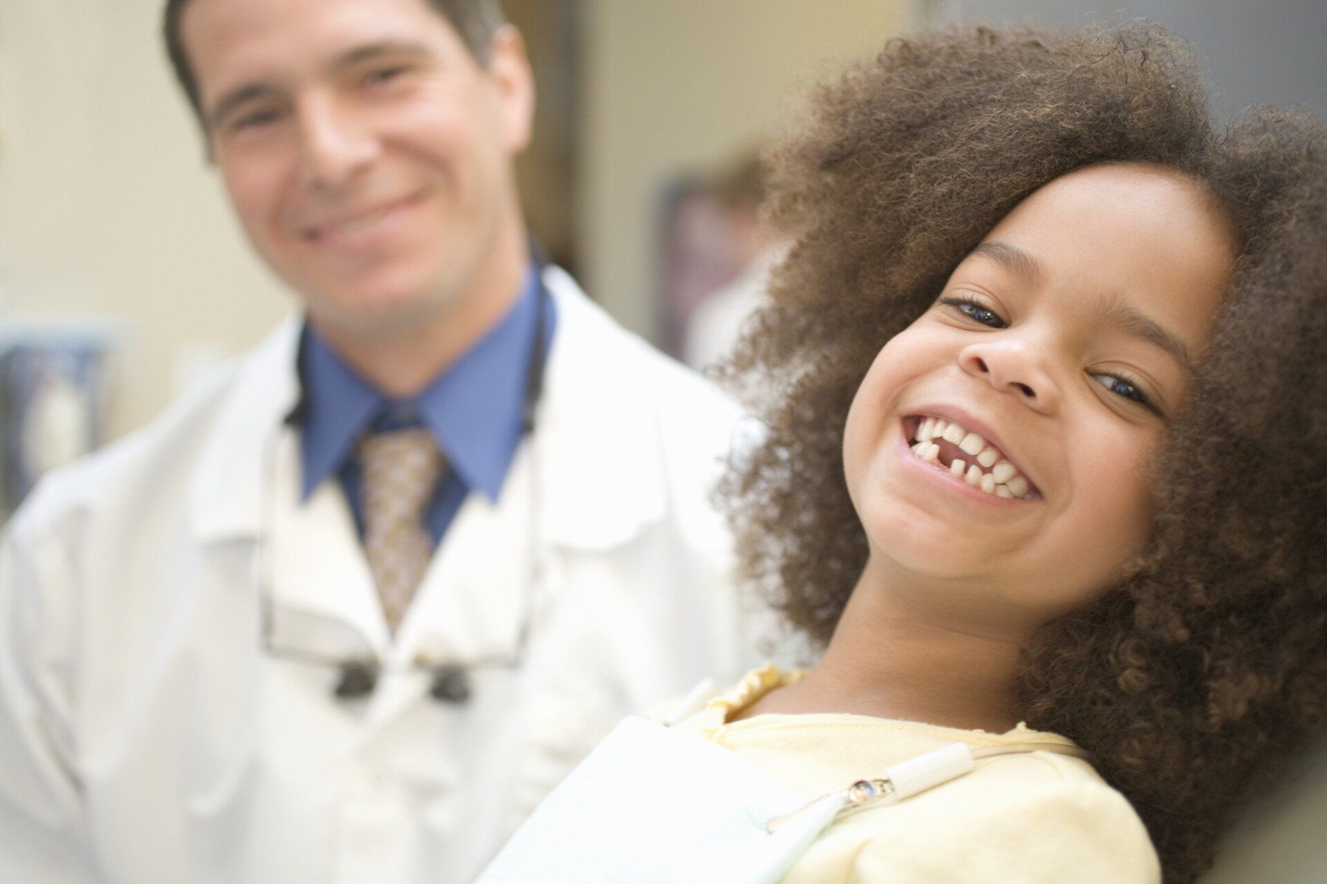 Smiling Kid With The Doctor At The Background — Inverness, FL — Citrus Dental Of Inverness PA