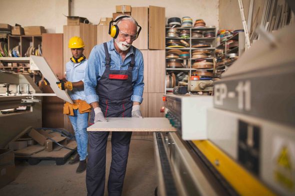 A picture of an experienced cabinet maker building cabinets