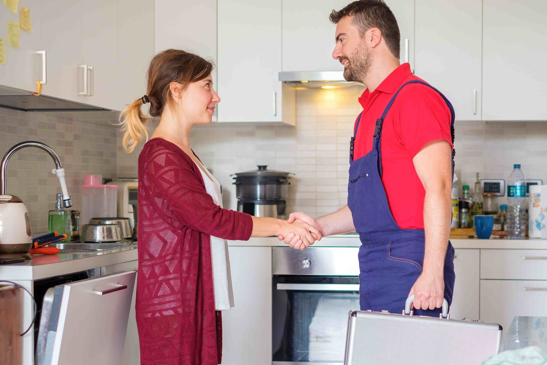 A homeowner shaking hands with a cabinet installer