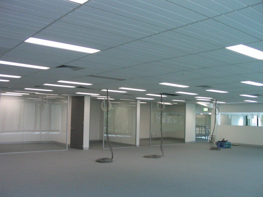 a large empty room with a lot of lights on the ceiling