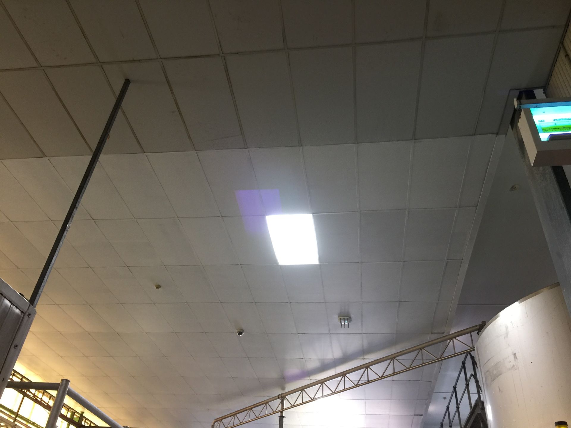 the ceiling of a building with a light on it
