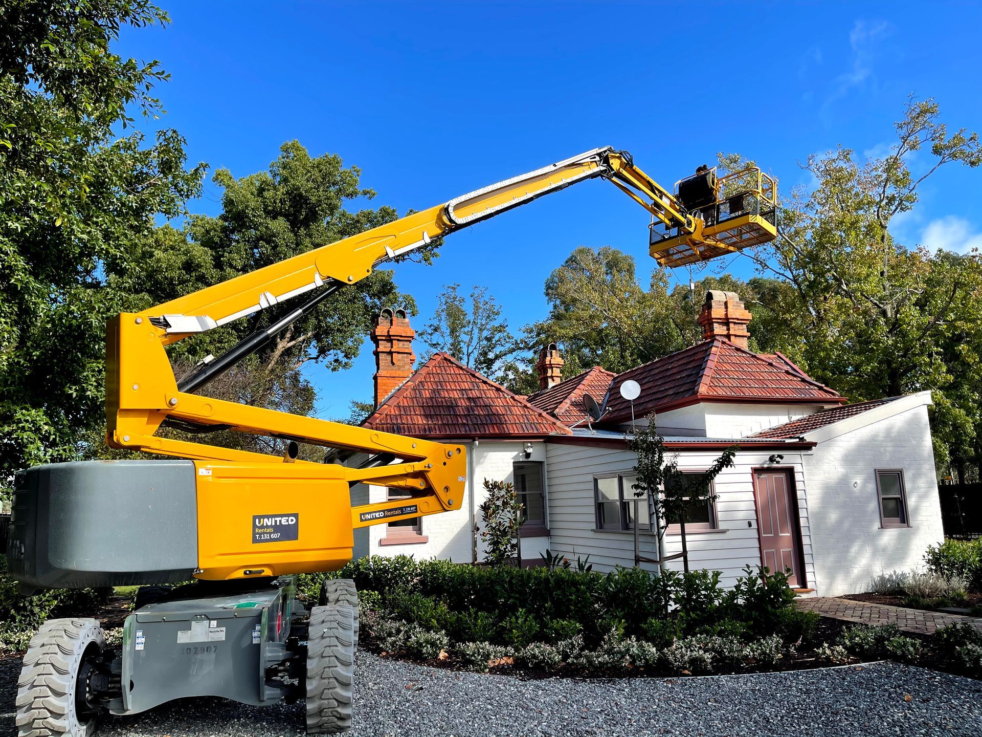 a yellow lift is sitting in front of a house .
