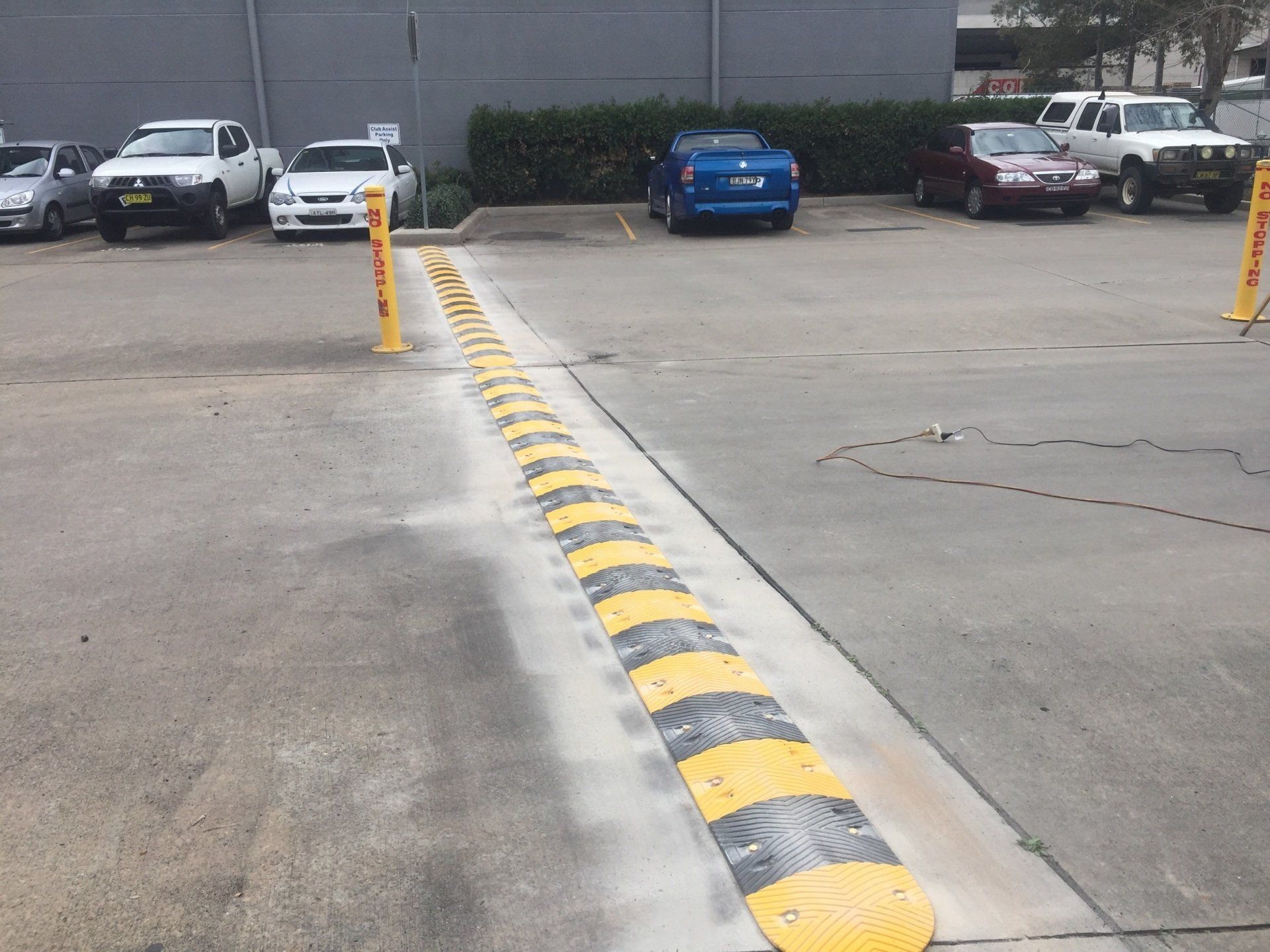 a parking lot with a yellow and black speed bump