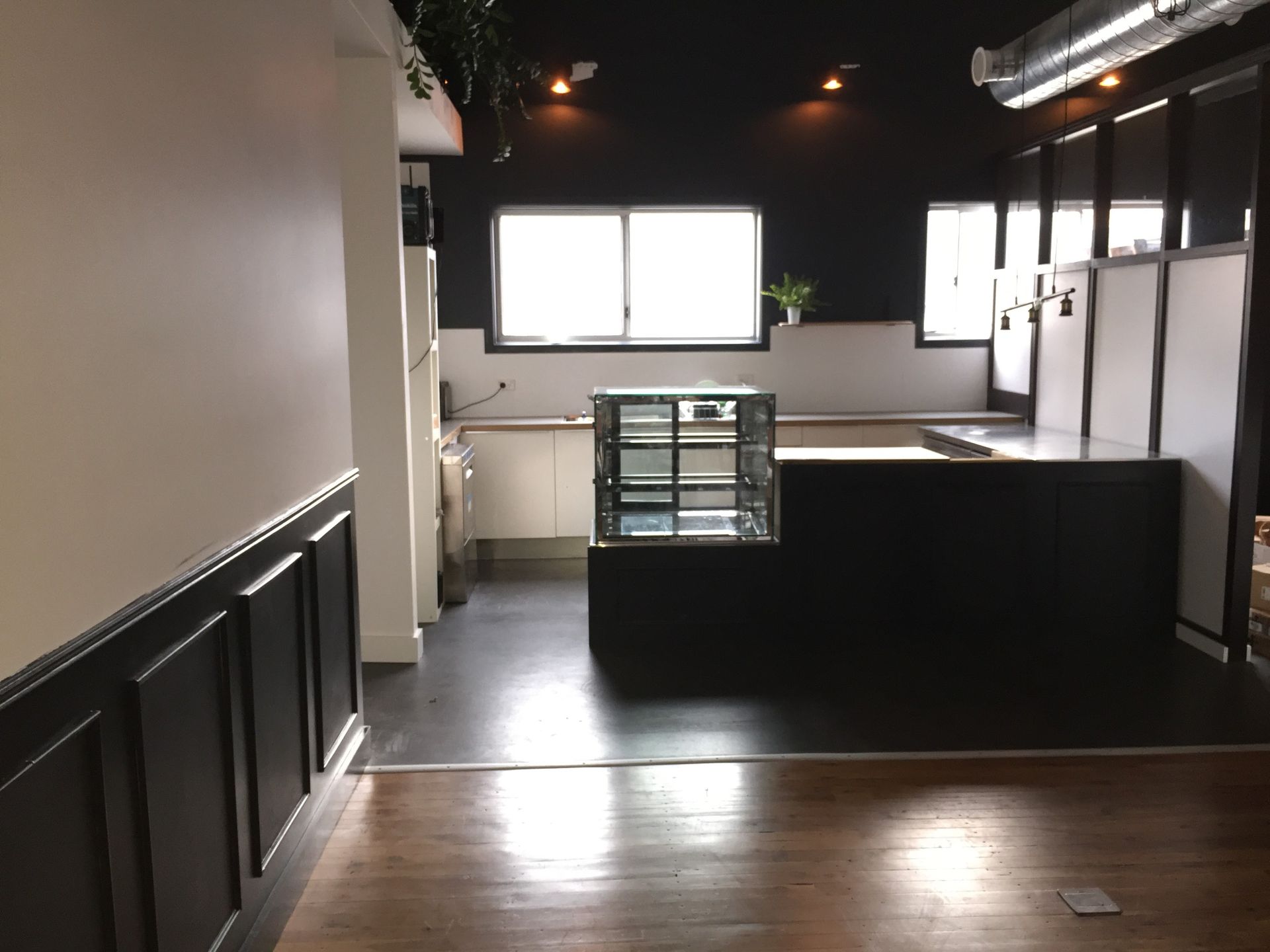 a kitchen with a glass display case in the middle