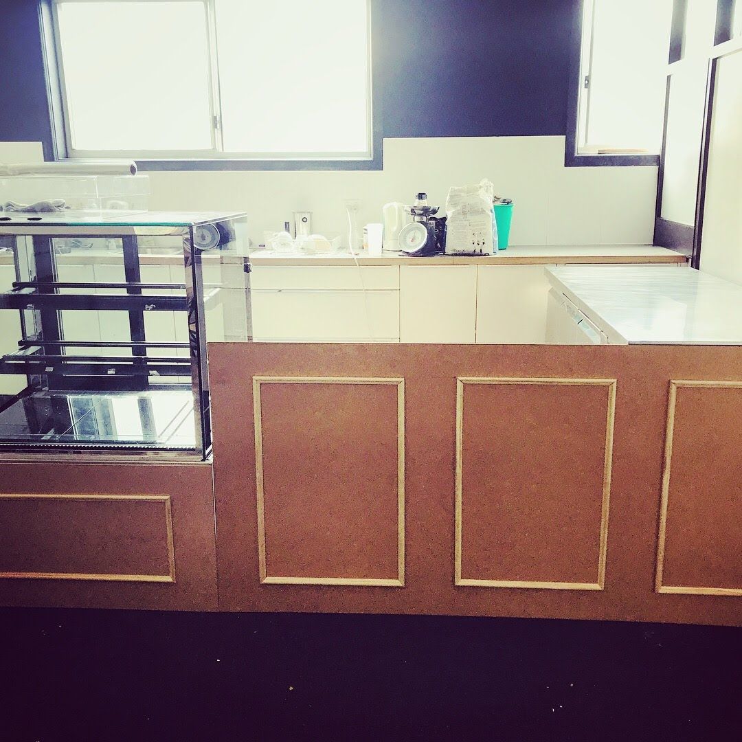 a kitchen with a counter and a display case