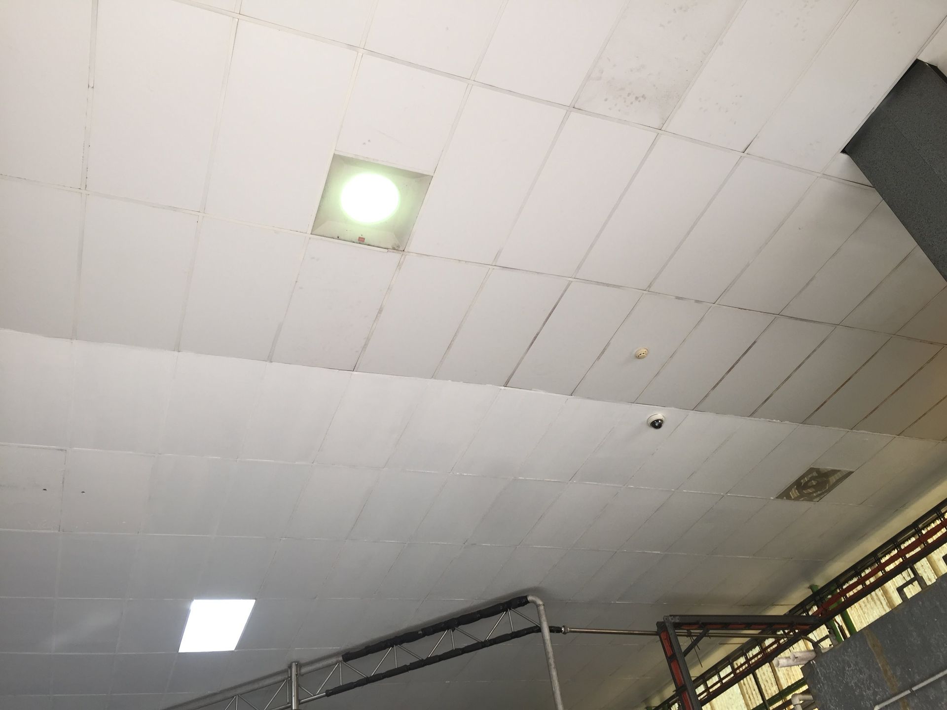a white ceiling with a square light in the middle of it .