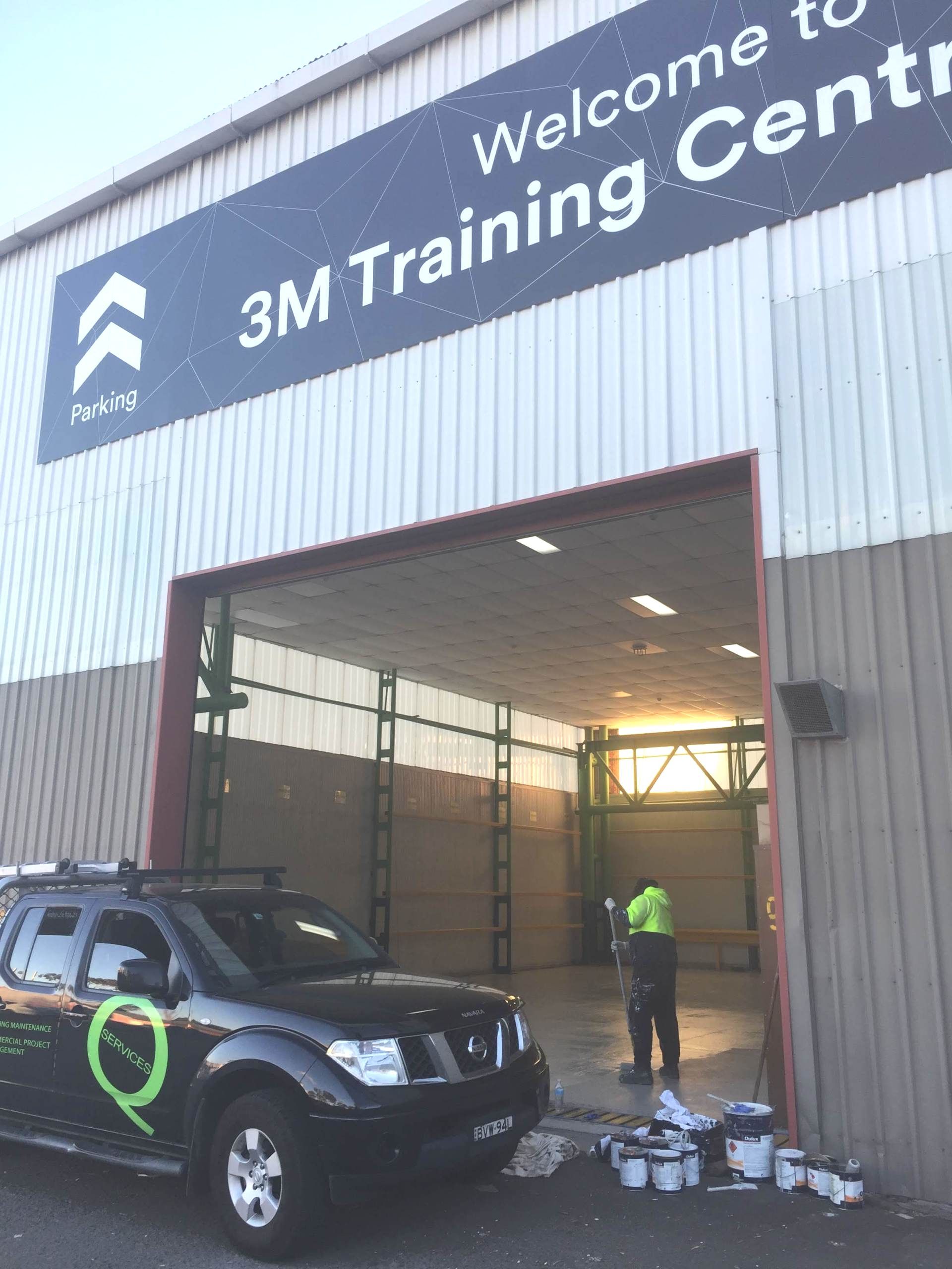 a car is parked in front of a building that says welcome to 3m training center