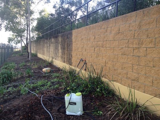 a brick wall is being cleaned with a sprayer .