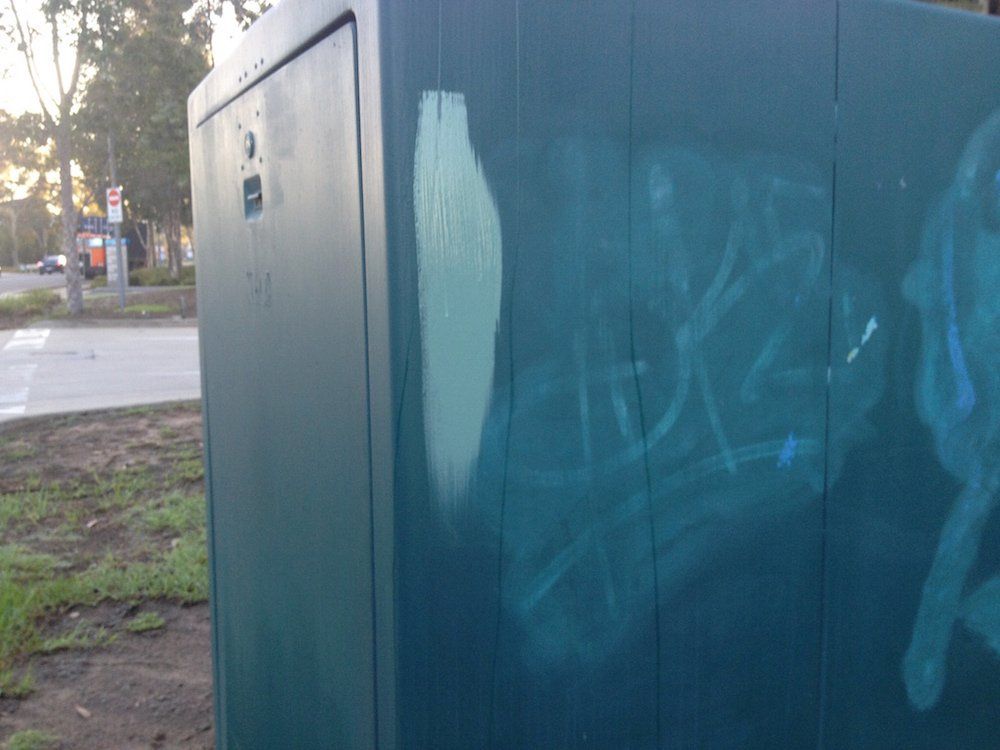 a green box with graffiti on the side of it .