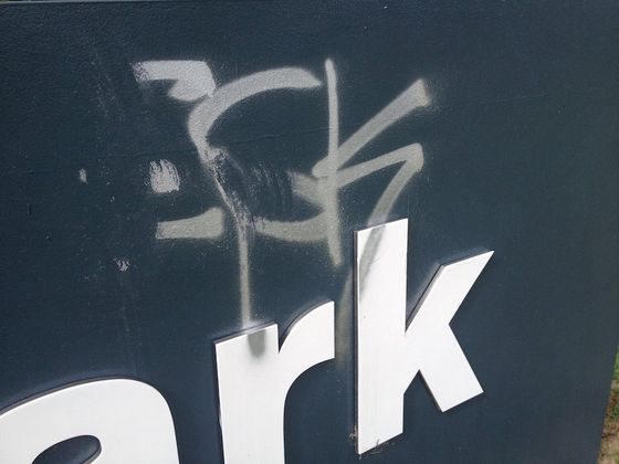 the word ark is spray painted on a blue surface