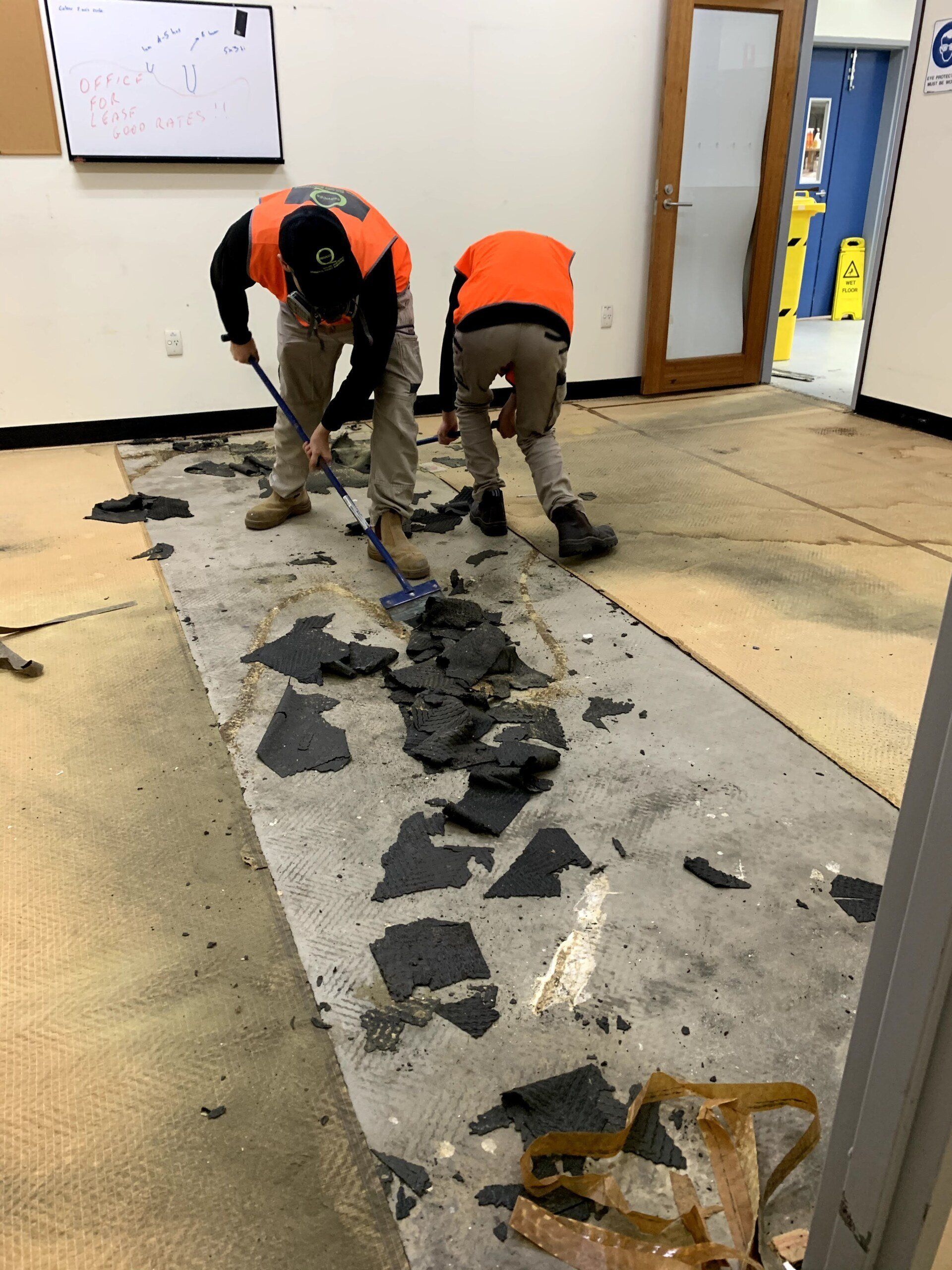 two men are working on the floor of a building
