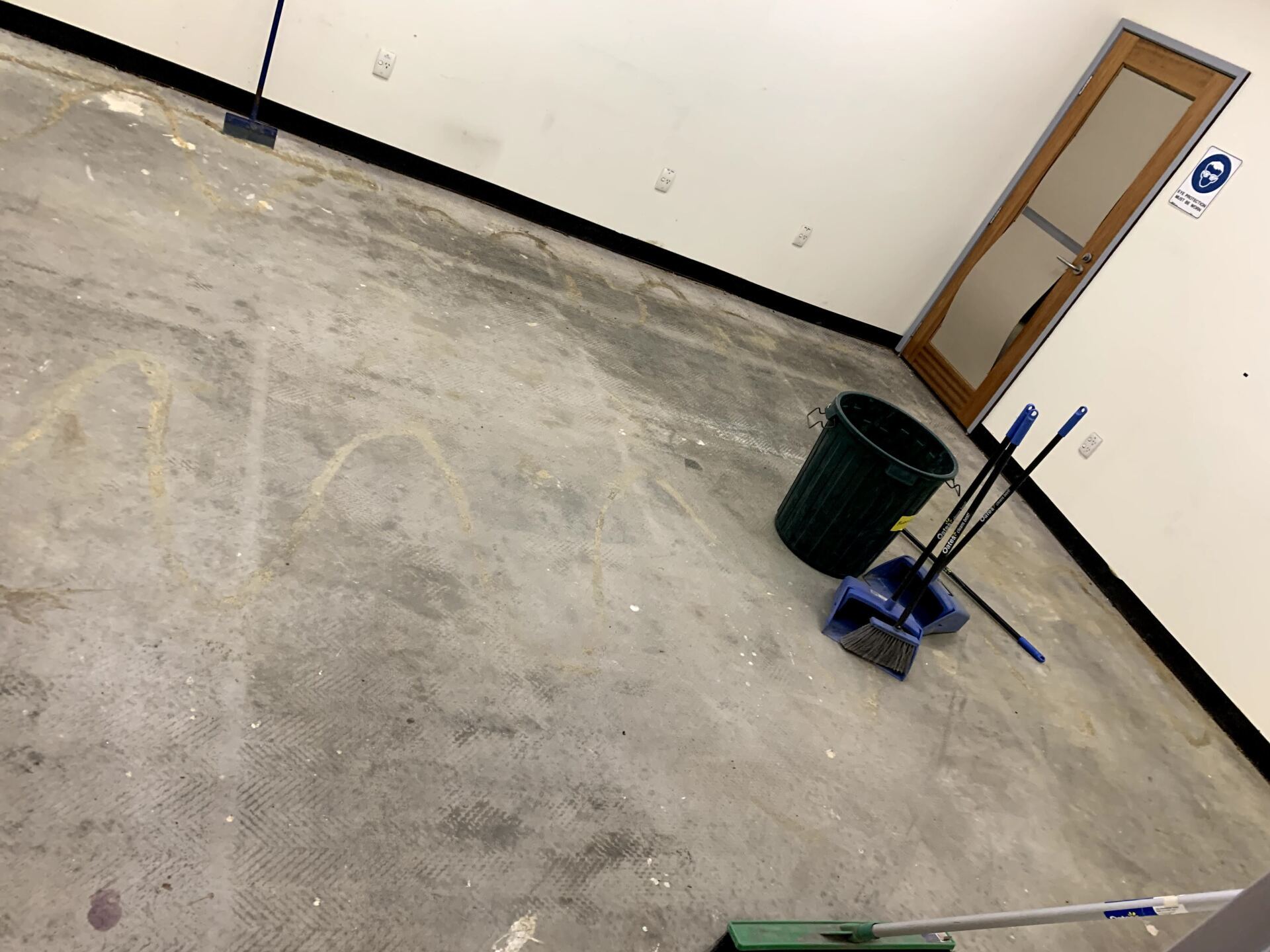 a room with a mop and bucket on the floor
