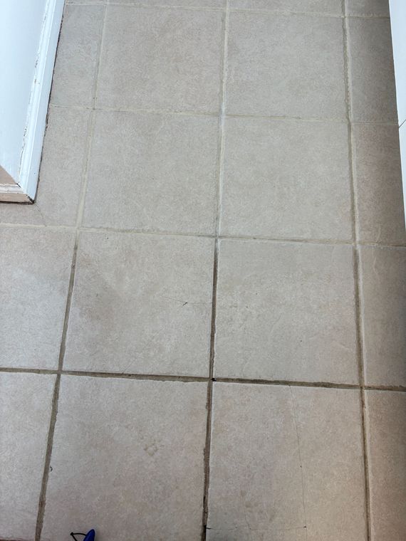 A close up of a tiled floor in a kitchen.