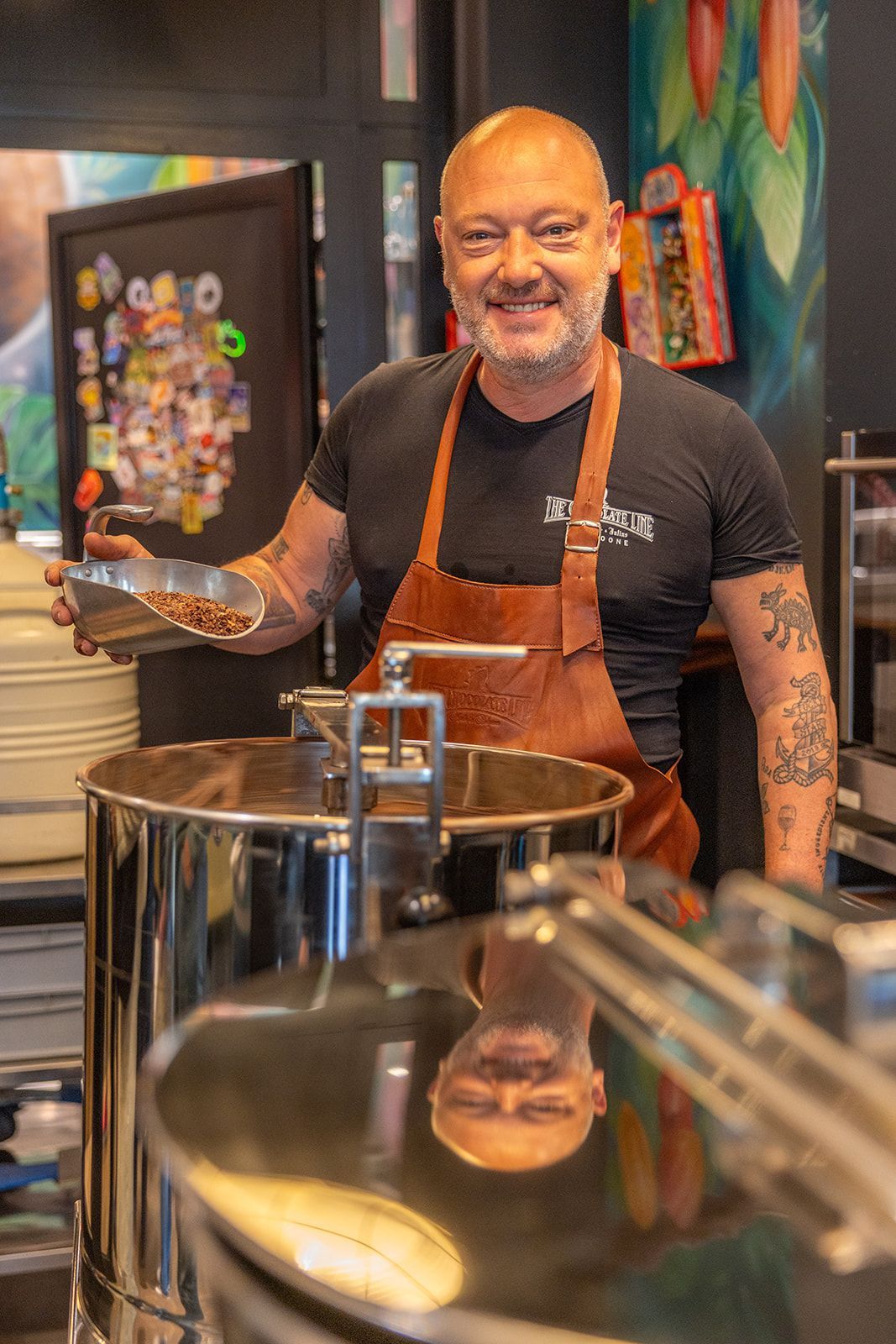 Interior view of a modern bar with a backlit shelf of various bottles and two bottles in the foreground.