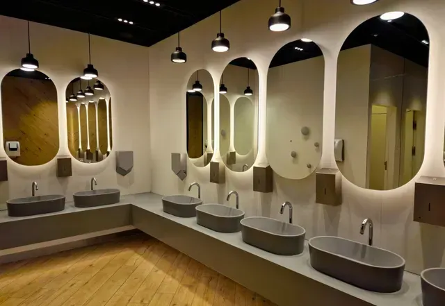 A bathroom with a lot of sinks and mirrors