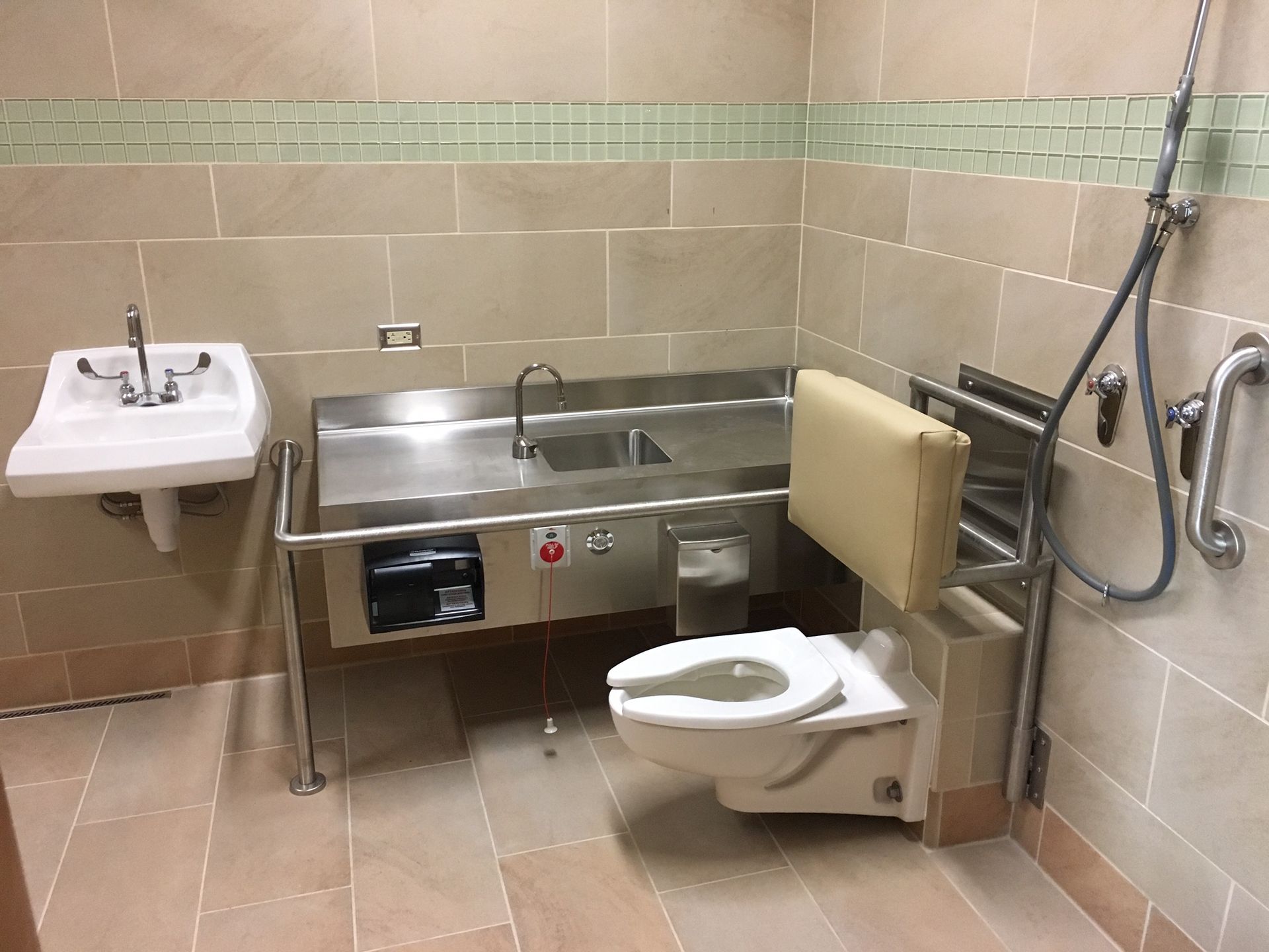 A bathroom with a toilet , sink , and shower.