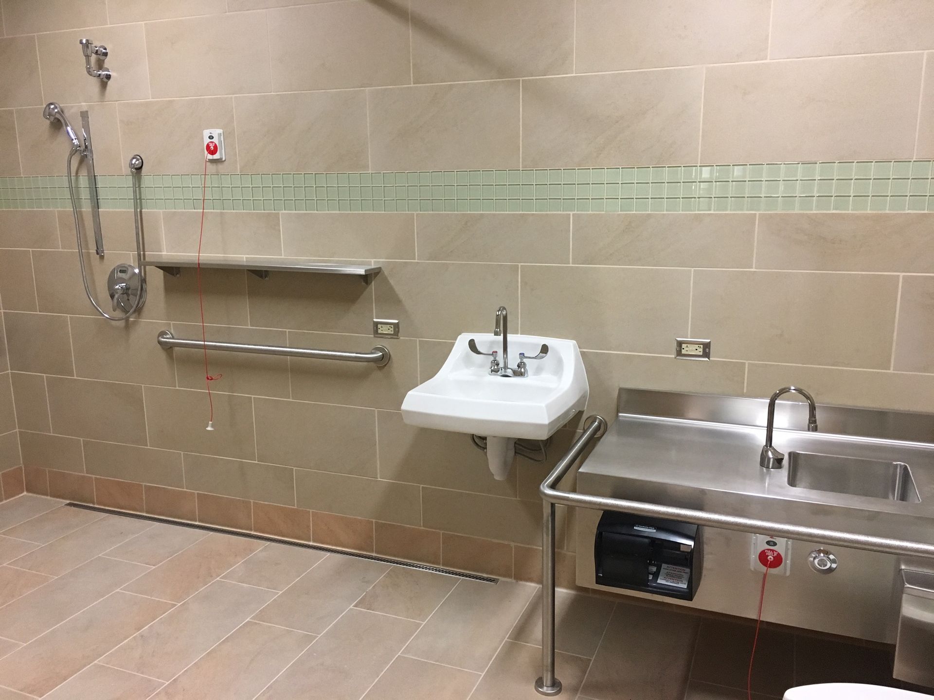 A bathroom with a sink and a shower.