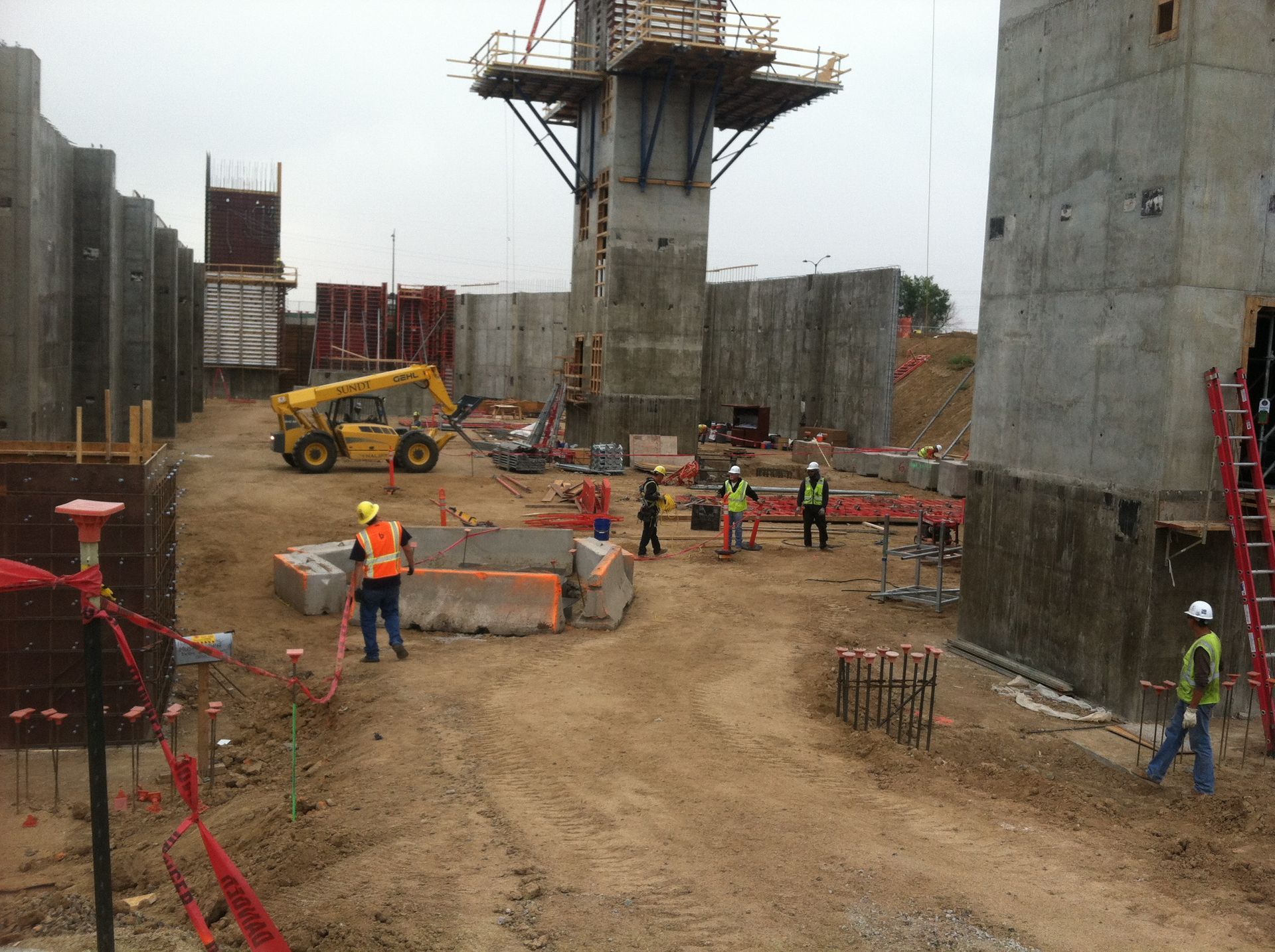 Construction workers are working on a large concrete structure