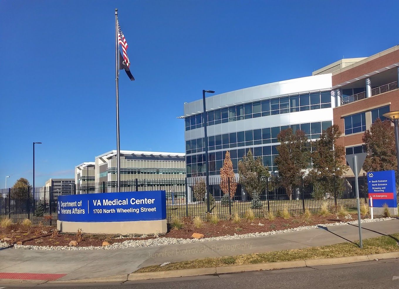 A large building with a blue sign in front of it.